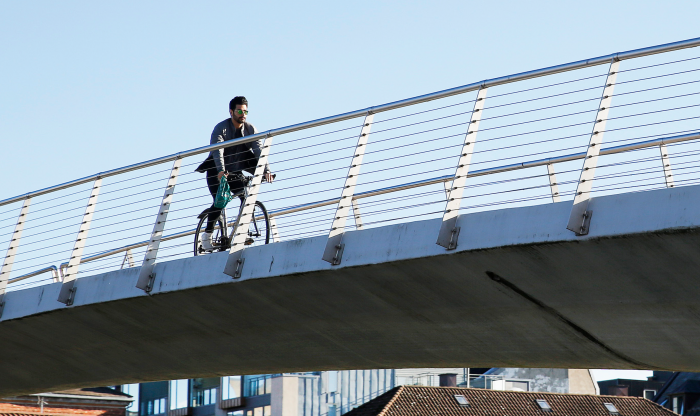 Man cycling on a bridge 