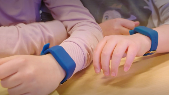 Photo of fitbits on children's arms