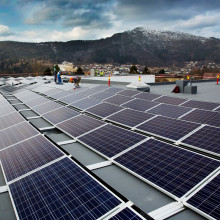 Solar cell and workers in front of mountains